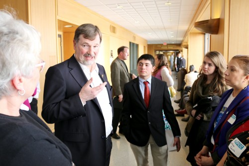 State Rep. Brad Witt talks with the PCC legislative group led by Rock Creek Campus President Sandra Fowler-Hill (left) in the hall of the state's Capitol Building.