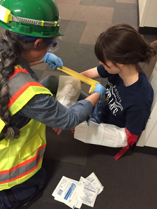 A C-CERT team member assists a 'victim' during the Cascade earthquake simulation.