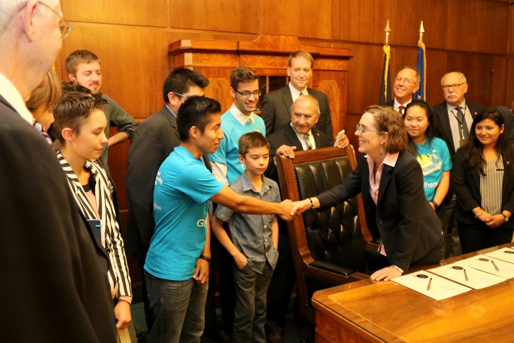 Gov. Kate Brown signed House Bill 3063, or known as the “Aspirations to College” bill that is based on PCC’s Future Connect model, in front of many PCC students.