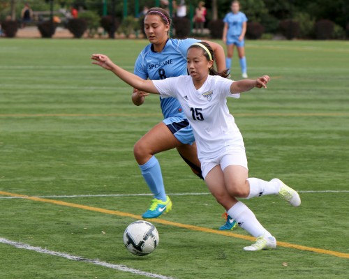 Nichola Wong, an international student from Malaysia, turns the corner on a Spokane CC defender in PCC's first game on Sept. 1.