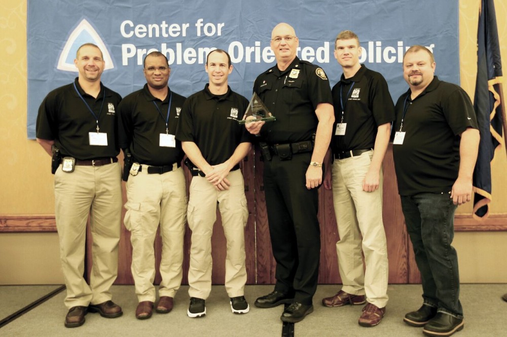 Portland Police Cmdr. Mike Leloff, third from right, and fellow officers accept their trophy as Herman Goldstein Award world finalists.