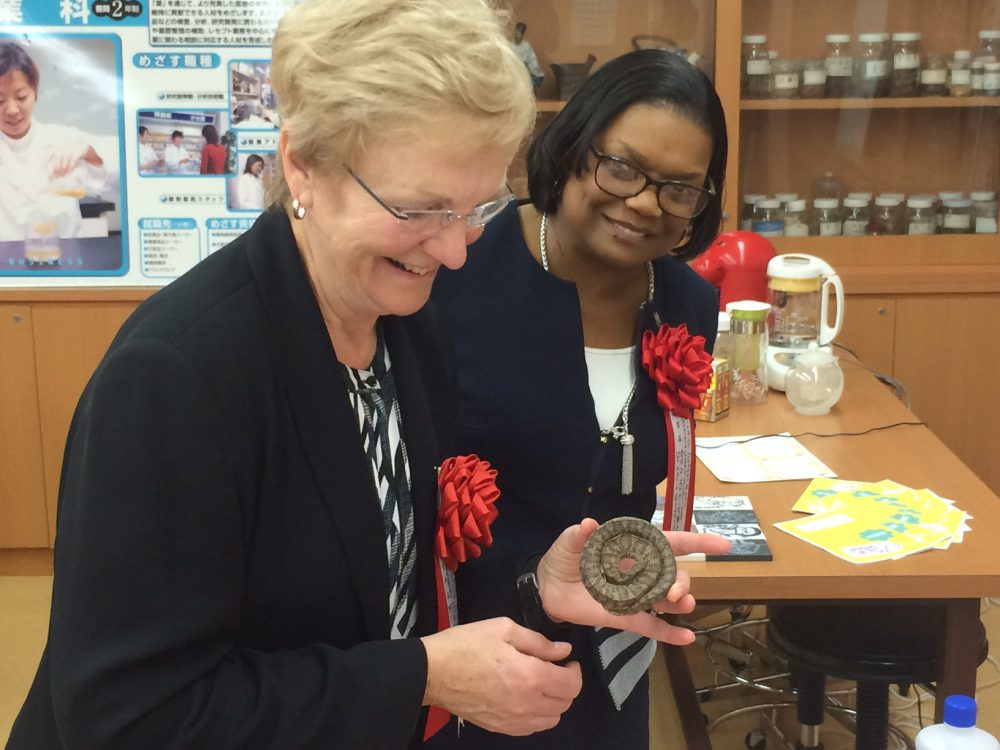 Joanne Harris, left, and Cascade Campus President Karin Edwards get up close and personal with traditional Japanese medicine.