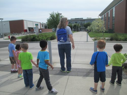 Children from the preschool class at the YMCA Child Development Center make their way across Southeast Campus to enjoy story time in the Multicultural Center in Mt. Tabor Hall. 