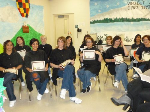 Cosmetology program graduates at the Coffee Creek Correctional Facility show their excitement.