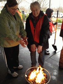 Event organizers provide fire pits to keep people warm at the Free Plant Day event.  