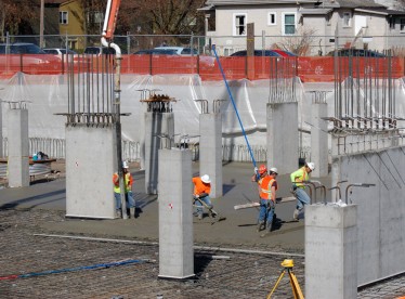Contractors pour the slab-on grade for the parking garage in early March 2013.