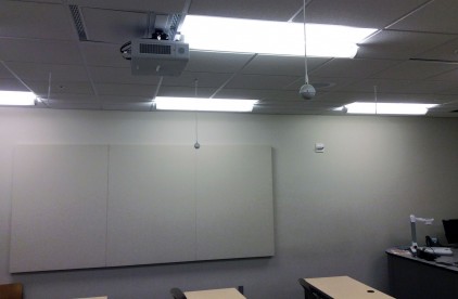 In an IVC classroom, "lecture capture" microphones suspended from the ceiling record an instructor's presentation and student discussions during a face-to-face class.