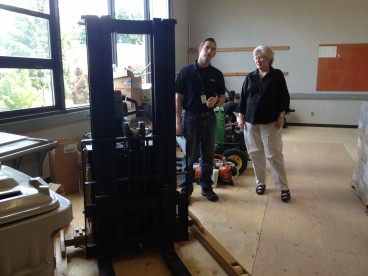 Former project manager Ty Harvey shows Sandra Fowler Hill, Rock Creek president, the upper storage area of Building 1. With the addition of 14 heavy-duty shelving units, FMS will be able to store a significant amount of supplies on the second floor of the newly-remodeled building.