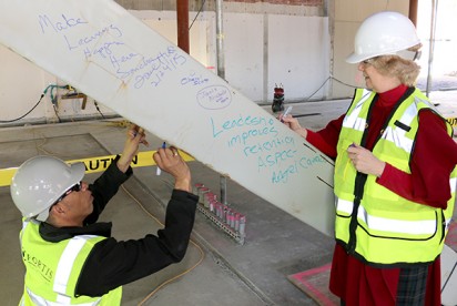 Faculty, staff and students leave their marks for posterity at the brace signing ceremony at Building 5 on Rock Creek Campus.