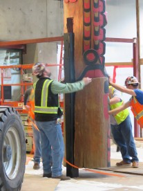 Erecting the totem in its new space required heavy equipment and many hands.